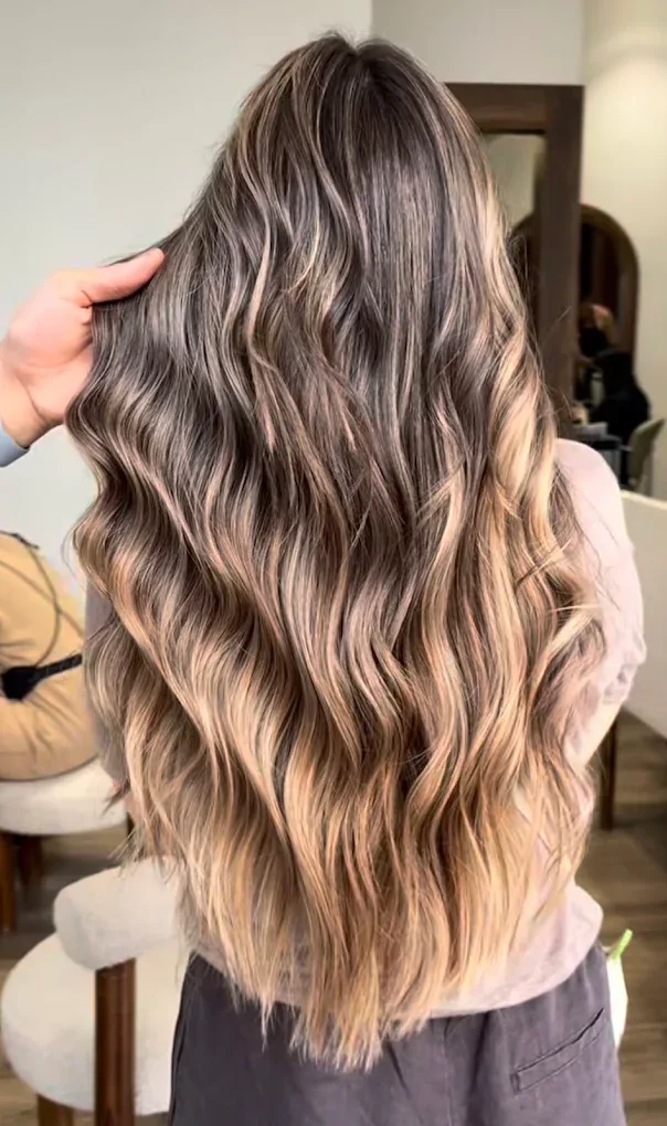 Balayage châtain aux reflets miel réalisé dans le salon